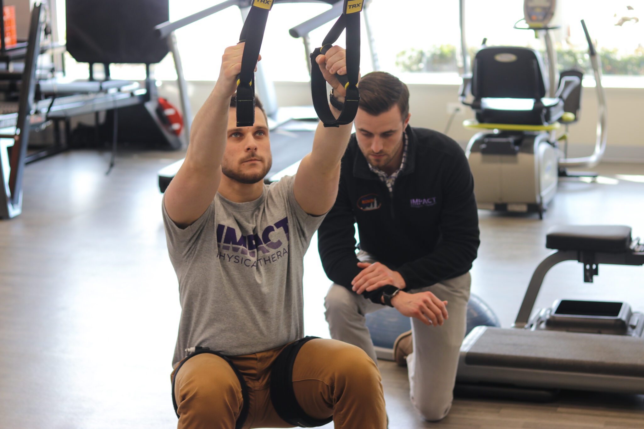 Instructor helping client with workout